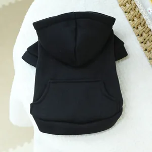 Detail view of black cotton pet hoodie with back pocket on soft white plush background