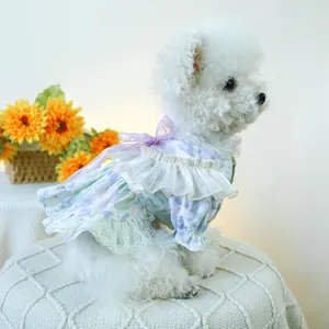 Detail of floral pet dress featuring layered ruffles and a purple mesh bow on the back