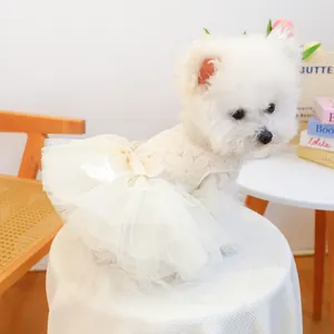 Detailed view of cream dog wedding dress with lace floral embroidery and tulle skirt
