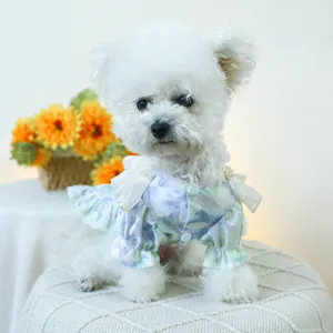 Close-up of cute floral pet dress with shoulder ruffles and button detail on a dog
