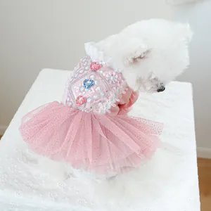 Close-up of pink pet dress featuring silver sequin embroidery and heart gems