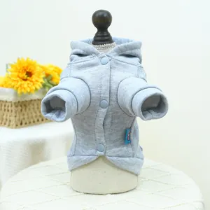 Close-up of light grey pet hoodie with blue buttons and soft fleece texture