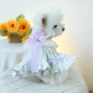 Detail of floral pet dress featuring a large purple silk bow and delicate lace trim