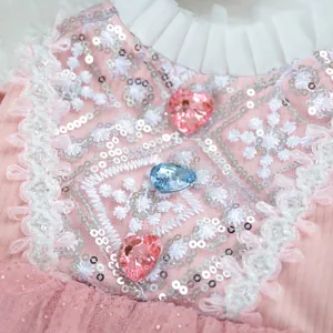 Close-up of pink pet tutu dress featuring sequin embroidery and heart-shaped gems