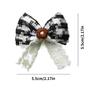 Detail showing bow hair clip with houndstooth fabric, brown flower, and white lace, 5.5cm