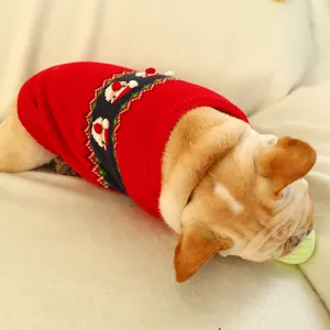 Close-up of red Christmas knit sweater with Santa Claus pattern on a French Bulldog
