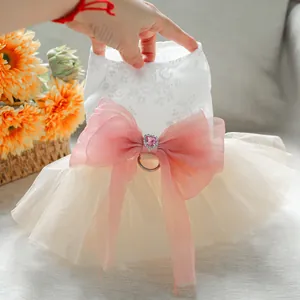 Detail of floral lace embroidery and large pink bow with heart crystal on pet dress