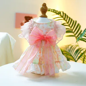 Detailed view of floral pet dress with a pink organza bow and white lace trim