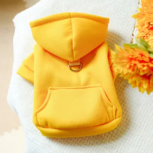 Detail of bright yellow pet hoodie featuring metal D-ring for leash and small kangaroo pocket