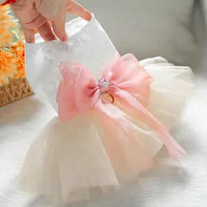 Detail of pet wedding dress with lace top, fluffy tulle skirt and pink heart rhinestone bow