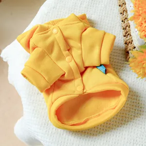 Detail of yellow pet hoodie showing snap buttons and soft fleece lining texture