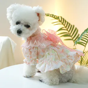 Close-up of pink floral pet dress featuring delicate lace ruffles and a large mesh bow