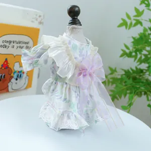 Detail of floral pet dress with lace edges and a large purple bow decoration
