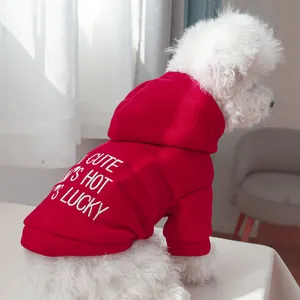Detail of red pet hoodie featuring white embroidery and ribbed cuffs for small dogs