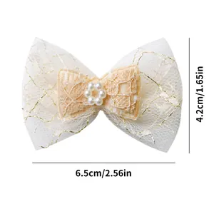 Detail of white lace pet bow hair clip with gold embroidery and faux pearls 6.5cm