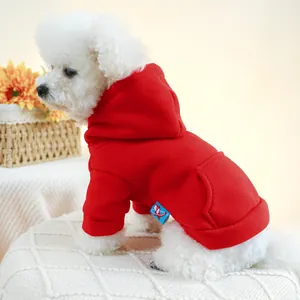 Detail of red hooded dog sweatshirt featuring functional back pocket and soft cotton texture