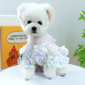 Detail of floral pet dress showing delicate lace trim and large purple mesh bow on back