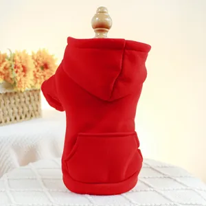 Detail view of red pet hoodie with kangaroo pocket on a wooden pet mannequin stand