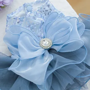Close-up of blue sequin pet dress with a large tulle bow and sparkling crystal center