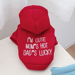 Macro shot of red pet hoodie featuring detailed white slogan embroidery for small dogs