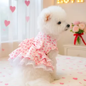 Pink pet princess dress with red hearts, large bow, and lace ruffles for small dogs