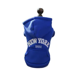 Royal blue pet hoodie with white New York print on dark wood mannequin stand
