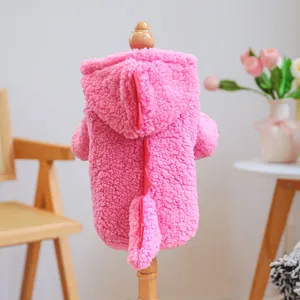Pink plush dinosaur pet hoodie with red soft back fins on a wooden model stand