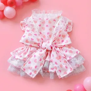 Pink heart print dog dress with lace trim and bow for small pets on pink background