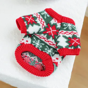 Close-up of festive Christmas dog sweater with snowflake patterns and red ribbed neck