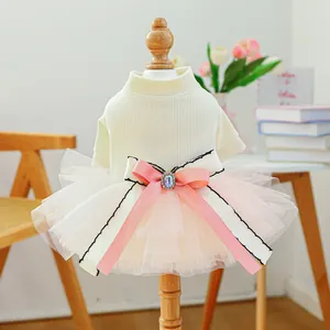 Detail of pet dress featuring floral tulle skirt and large bow with center crystal