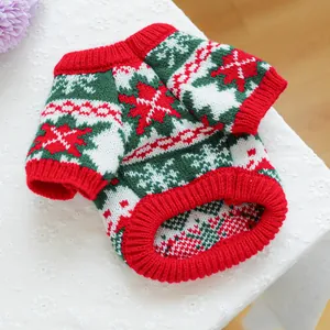 Close-up of knit pet sweater with festive red reindeer and snowflake patterns