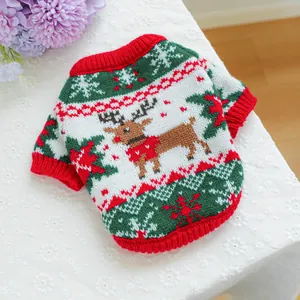 Detail of knitted Christmas pet sweater with reindeer pattern on white lace background