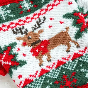 Detailed knit texture of a Christmas reindeer pet sweater with red and green snowflake patterns