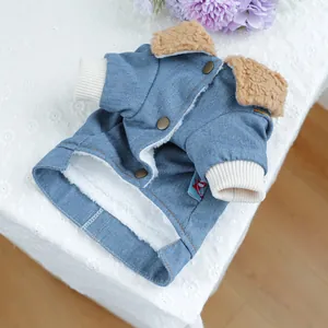Detail of warm pet denim jacket with brown lamb wool lining and bronze button closure