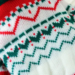 Close-up of festive red, green and white knitted pattern for pet holiday sweaters