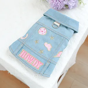 Detail der blauen Denim-Haustierweste mit Howdy-Stickerei und metallischem D-Ring