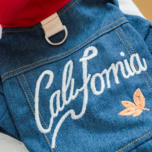 Detail van de blauwe denim hondenjas met California borduursel en metalen D-ring voor riem