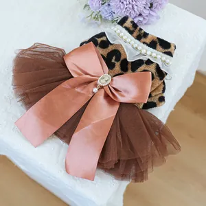 Detail of leopard print pet dress with pearl collar and layered brown mesh tutu