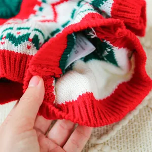 Detail of Christmas pet sweater with XS size tag and festive knit pattern textures