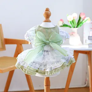 Detail of pet dress with a large green organza bow and layered lace embroidered skirt