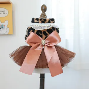 Detail of pet dress featuring leopard faux fur, lace collar, and a large pink satin bow