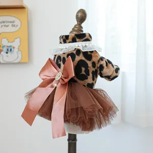Detail of leopard print pet dress with satin bow and vintage cameo pearl pendant