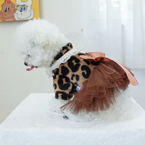 Detail of leopard print pet dress with pearl necklace and layered tulle skirt on a dog