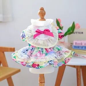 Close-up of floral dog dress with pink silk bow and heart lace detail on skirt