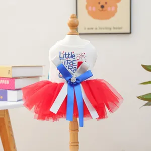 Detail of pet princess dress featuring a star embroidery and blue ribbon bow on a model