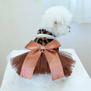 Pet dress detail featuring leopard pattern, brown satin bow, and layered mesh tulle skirt