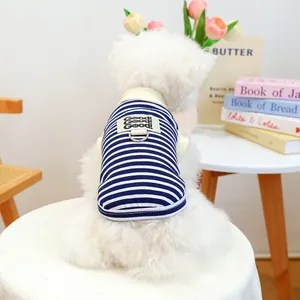 Close-up of blue and white striped dog vest with metal D-ring and Good! fabric label