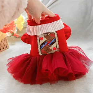 Detail of red pet dress with plush fabric, layered tulle skirt and metal D-ring for leash