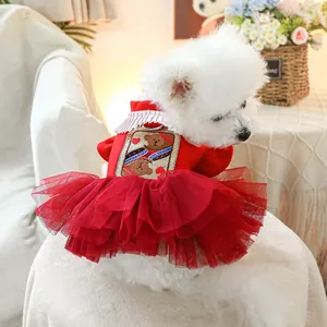 Detail of red pet dress featuring layered mesh skirt and teddy bear poker embroidery