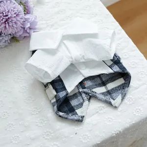 Detail of British style pet shirt with blue plaid pattern and white buttons for dogs
